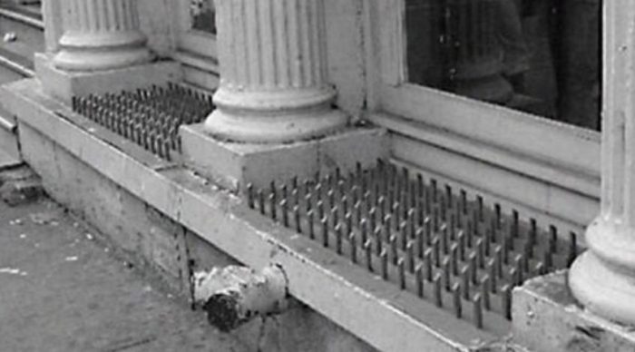 Anti Homeless Spikes in an American Window - many homeless are war veterans from the US Army
