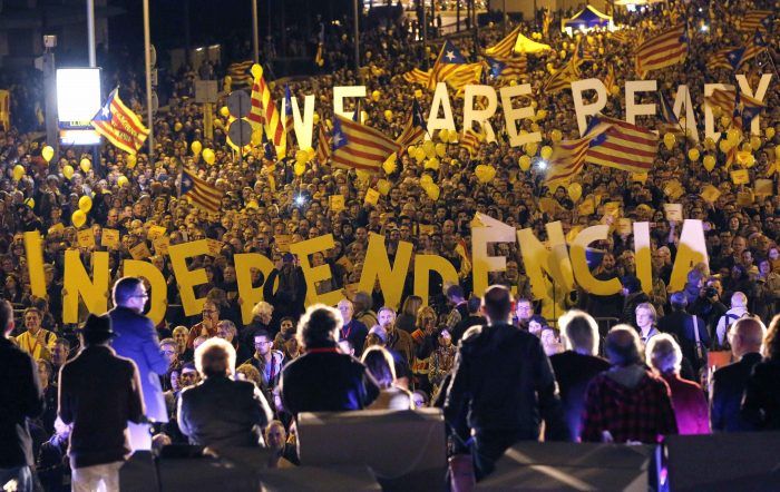 Pro-independence citizens hold up giant letters reading "We are ready, Independence" during the final meeting before the 9N (November 9) consultation, in Barcelona November 7, 2014. Among those on stage are Omnium Cultural President Muriel Casals (2nd R) and Catalan National Assembly (ANC) President Carme Forcadell (C). Catalans are expected to turn out in droves on Sunday to make their strongest show of force to date for breaking away from the rest of Spain in a symbolic independence referendum. But the chances of a formal vote on Catalan autonomy remain slim - partly because regional authorities are themselves divided over how far to go. REUTERS/Gustau Nacarino (SPAIN - Tags: POLITICS ELECTIONS TPX IMAGES OF THE DAY)